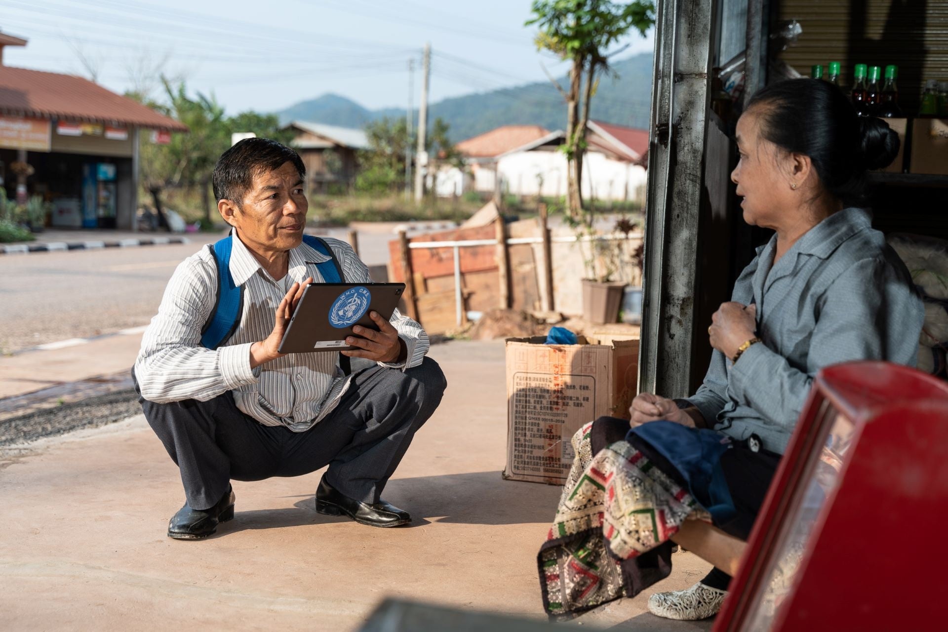 Ministry of Health official conducts a survey with store owner